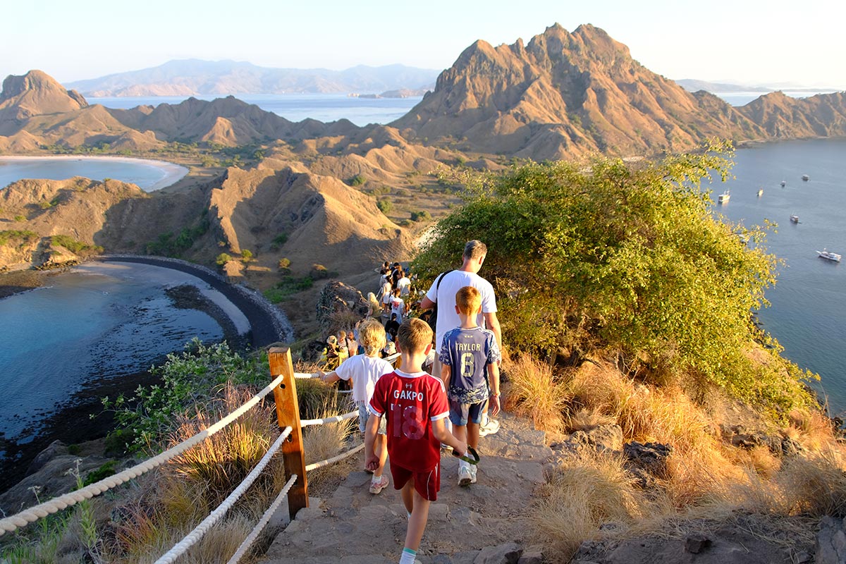 Visitors trekking along the Padar Island hillside trail